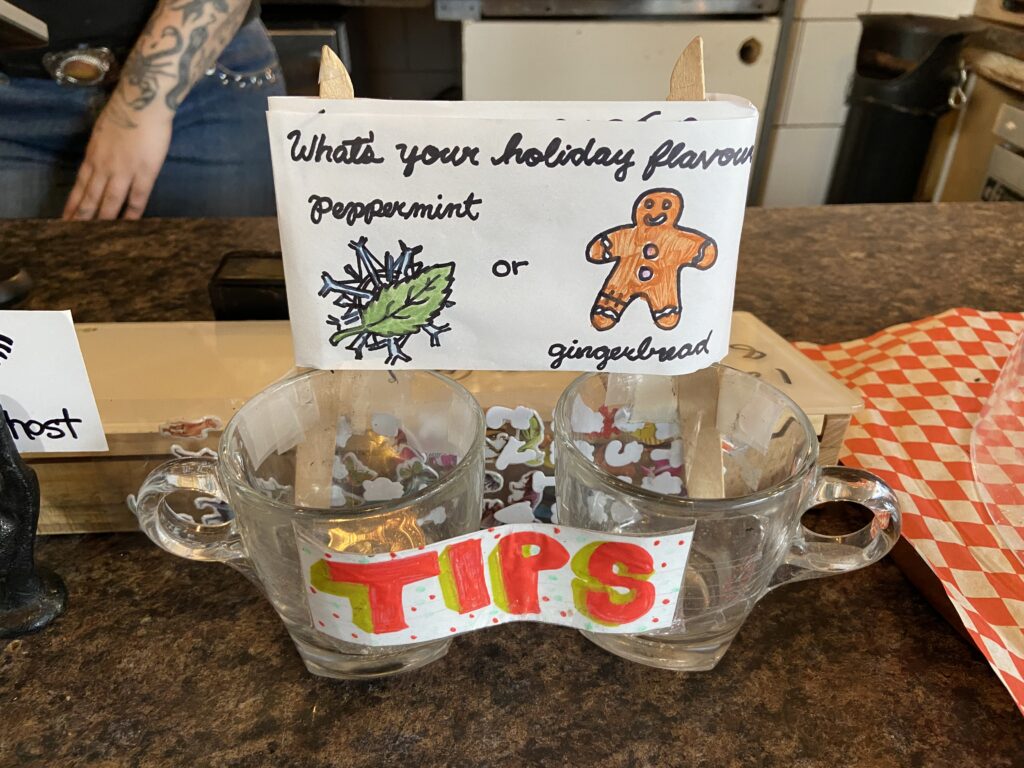 Two tip jars with the question: What's your holiday flavour, peppermint or gingerbread