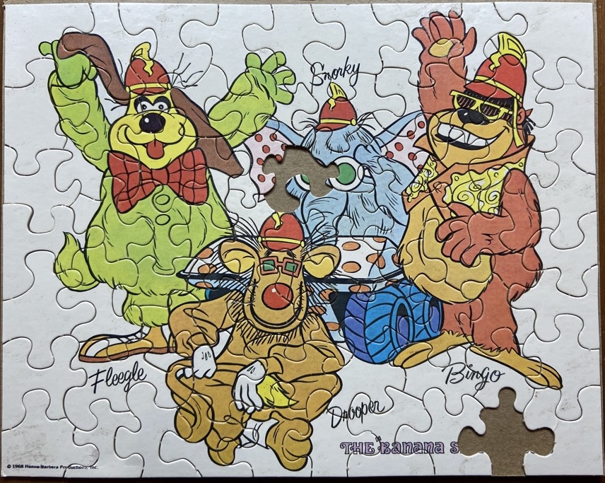 A completed puzzle, with 2 pieces missing, featuring the four main characters from The Banana Splits show.