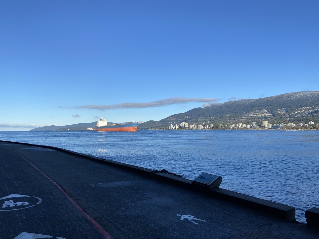 A cargo ship approaching Prospect Point on the Stanley Park Seawall.