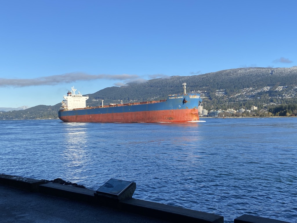 A cargo ship passing Prospect Point on the Stanley Park Seawall.