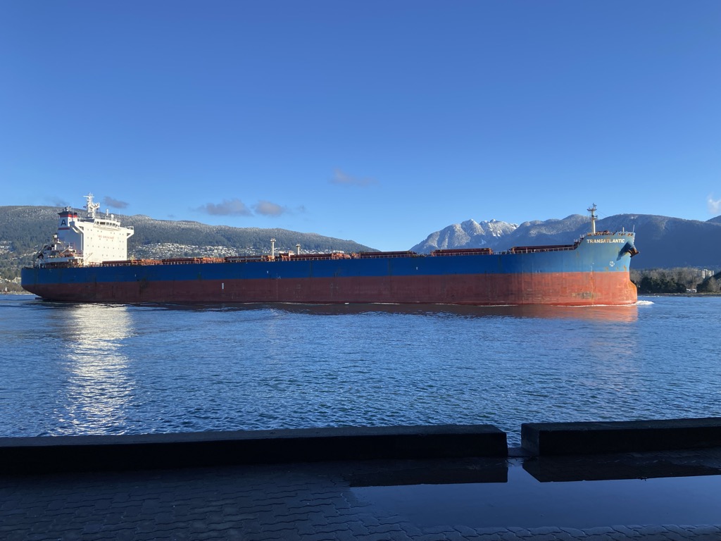 A cargo ship passing Prospect Point on the Stanley Park Seawall.